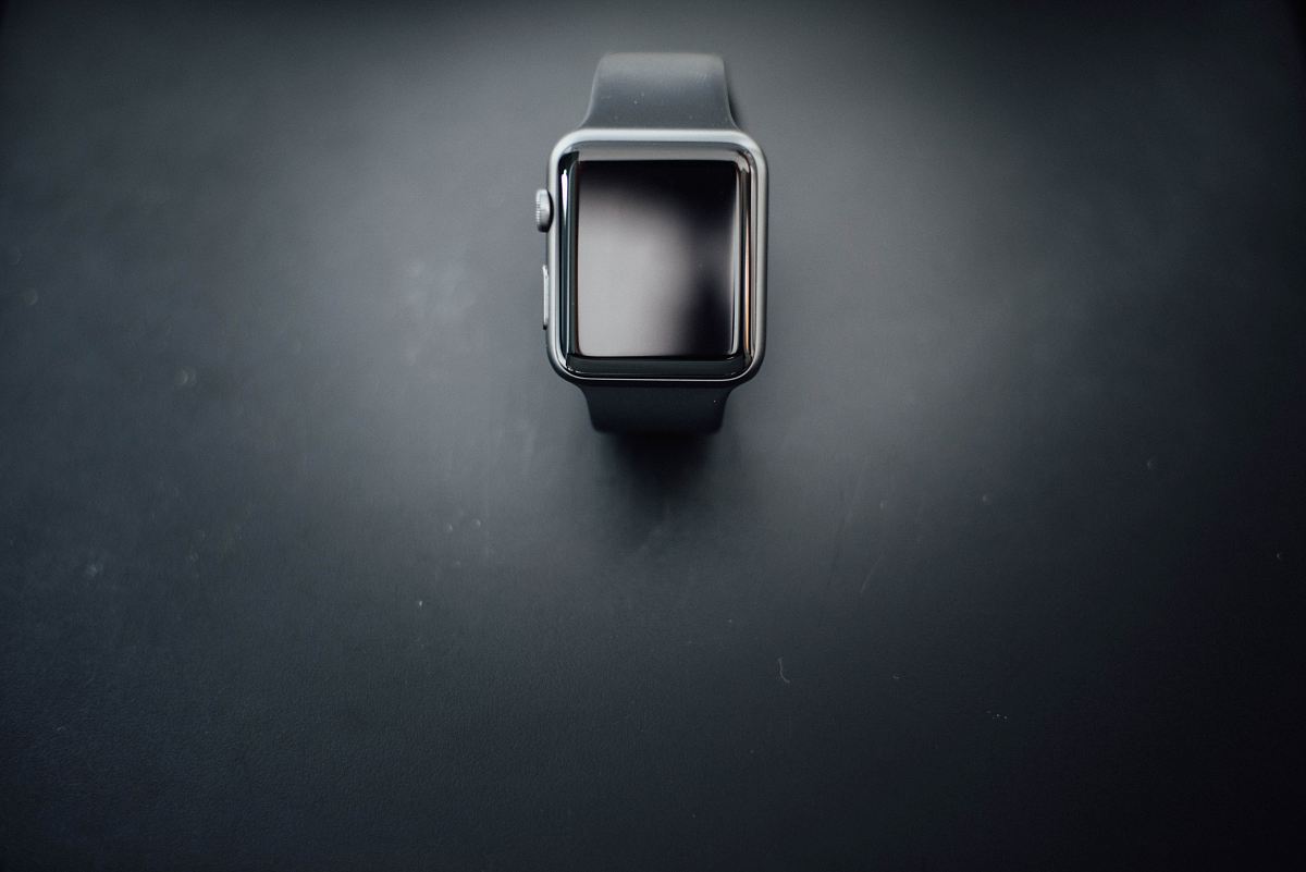shallow focus photography of silver Apple Watch with black Sport Band